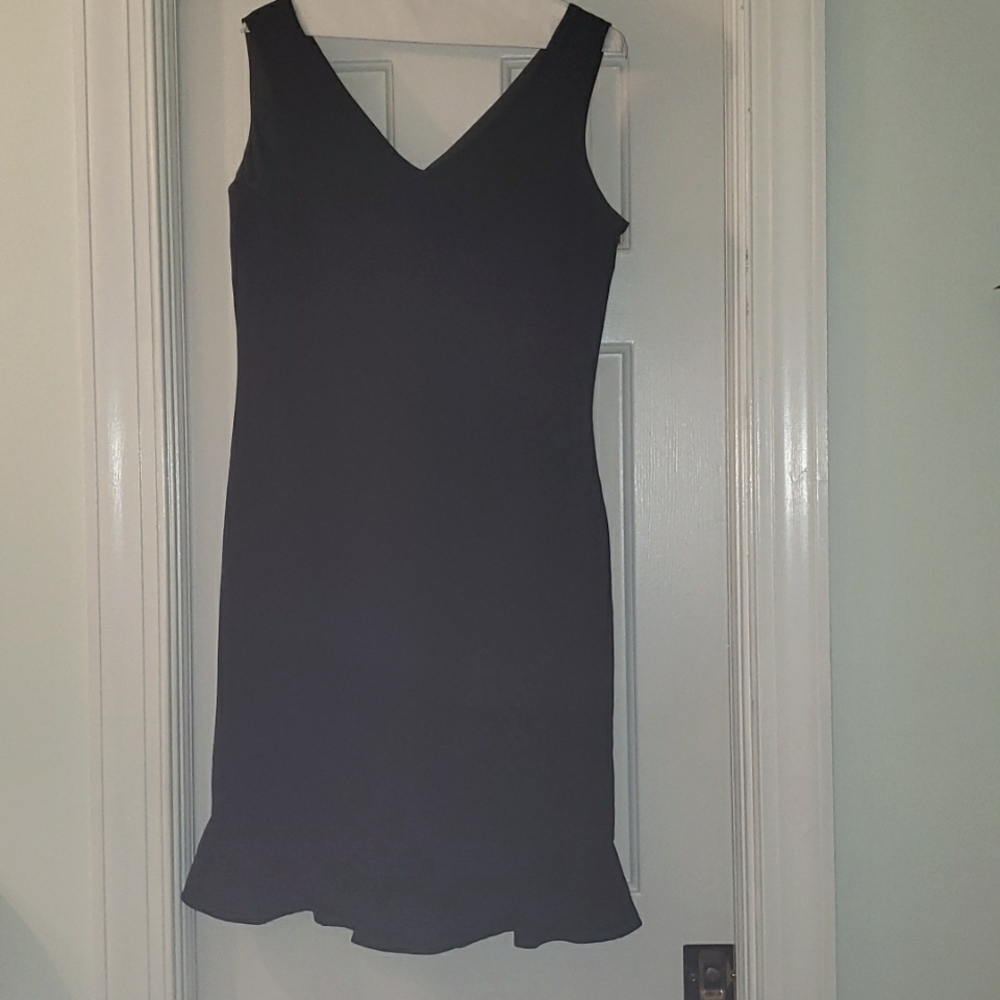 After five black sleeveless Studio 1 dress with black beads around the neck.